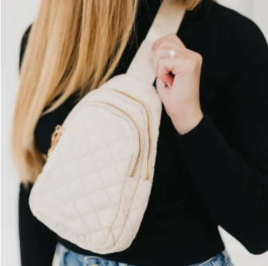 Women's sling cream colored puffer bag with gold zipper