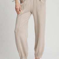 Women wearing stone colored active wear pants in stone color