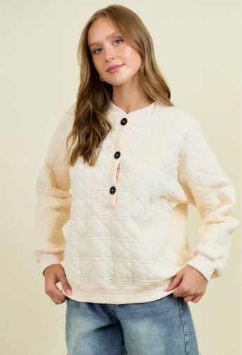 Cream quilted pullover with detail front buttons