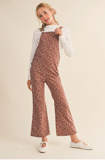 Girl wearing floral overall bibs