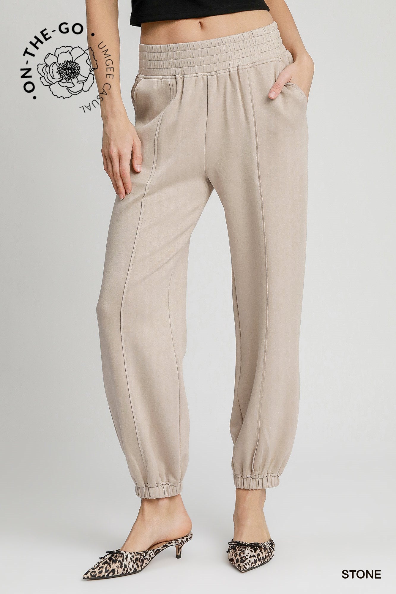 Women wearing stone colored active wear pants in stone color