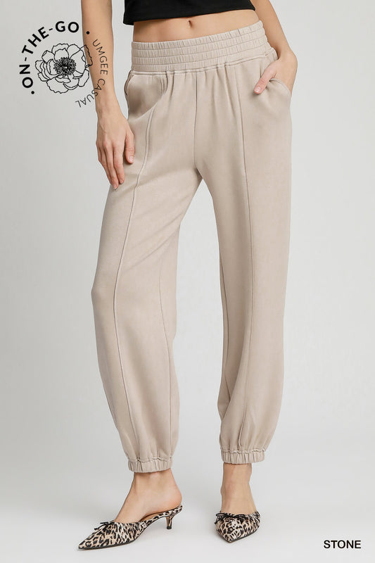 Women wearing stone colored active wear pants in stone color